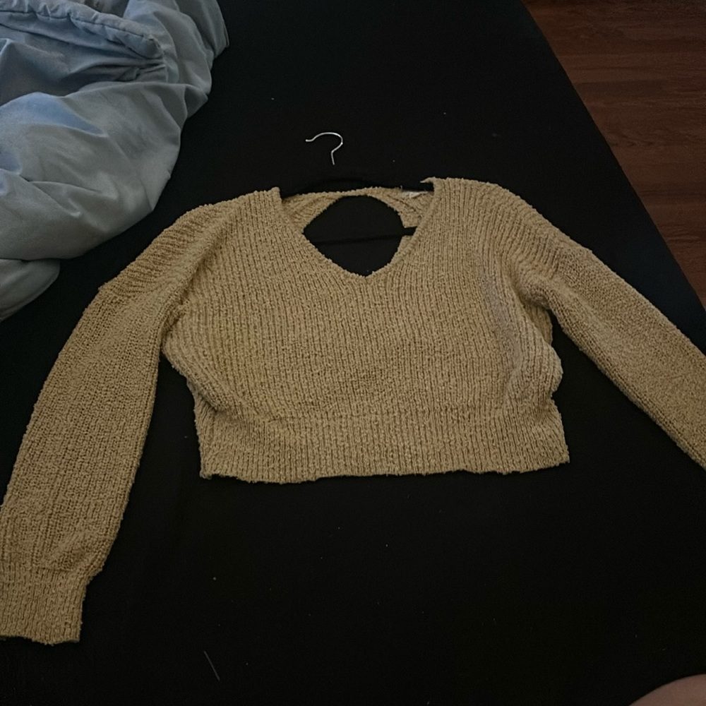 This is a cute v-nick sweater with a lighter yellow/tan color